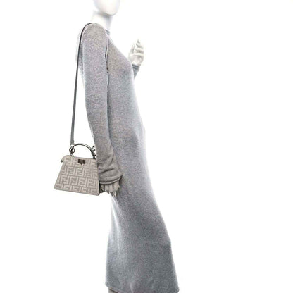Petite satchel with glittery crystal finish, top handle, and monogram front panel