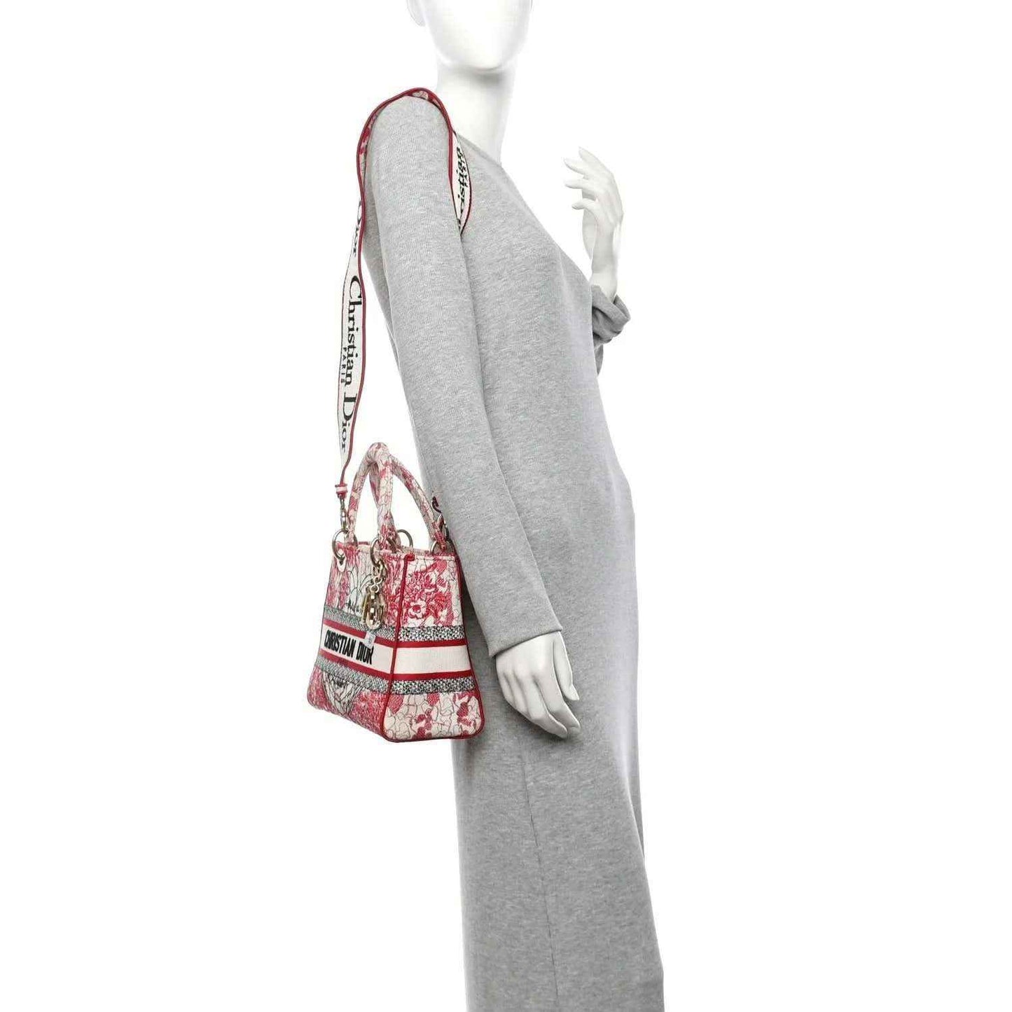 Embroidered canvas lady bag in red-and-white with shoulder strap and top handles.
