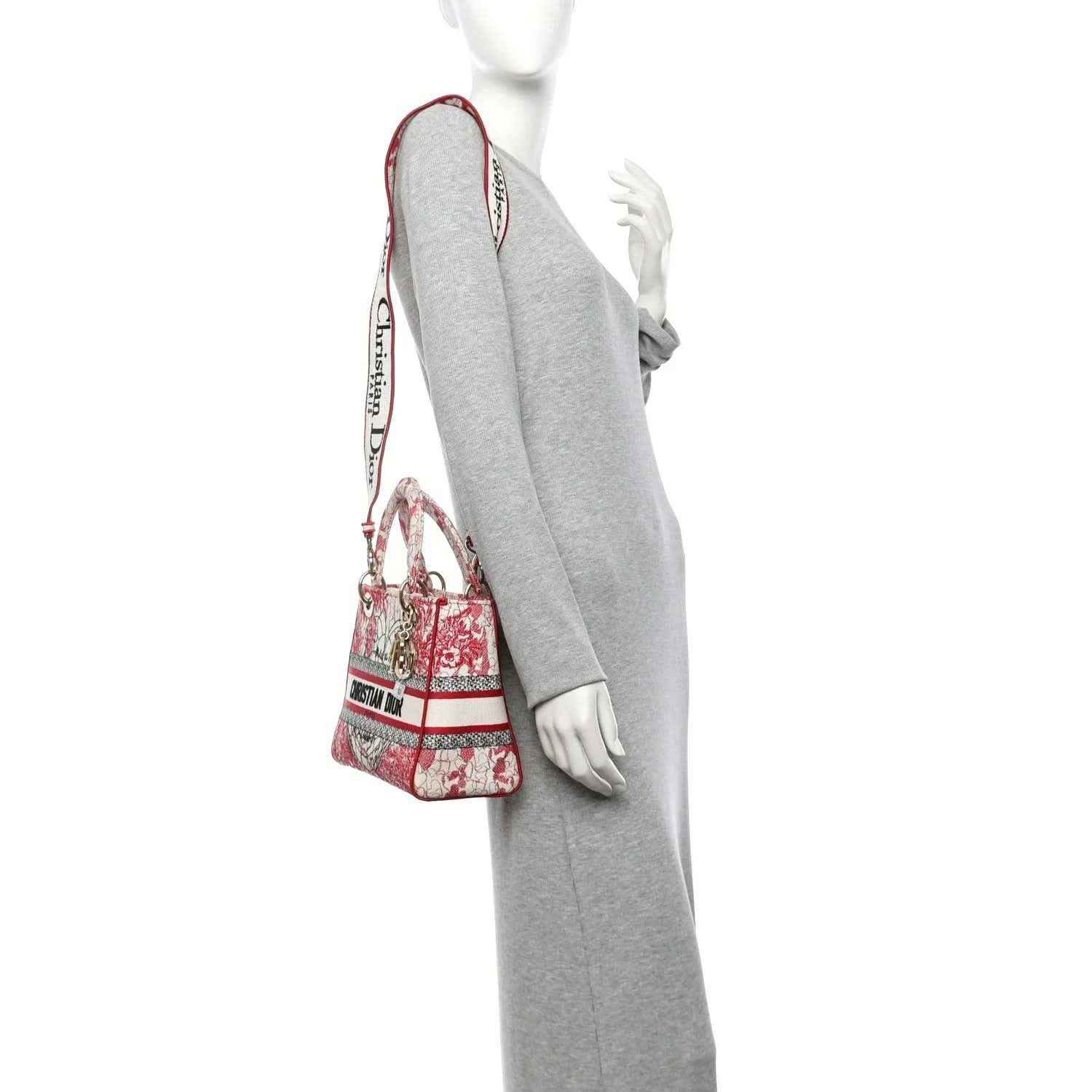 Embroidered canvas lady bag in red-and-white with shoulder strap and top handles.