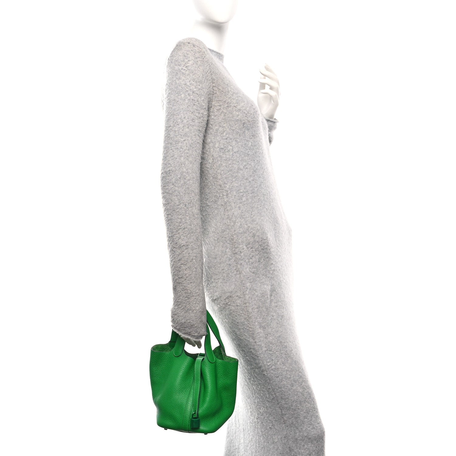 Picotin Lock 18 PM tote bag in green leather, carried by model with handles up