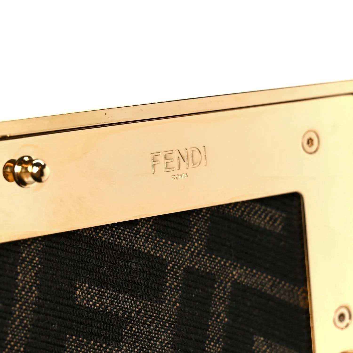 Fendi logo plate on gold-tone frame of woven leather clutch bag