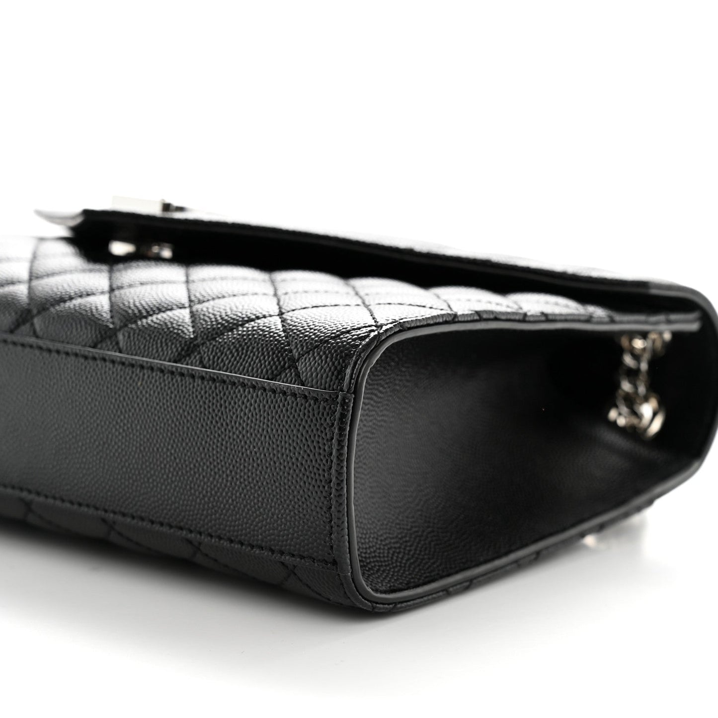 Black matelasse leather satchel with quilted paneling and top zipper opening