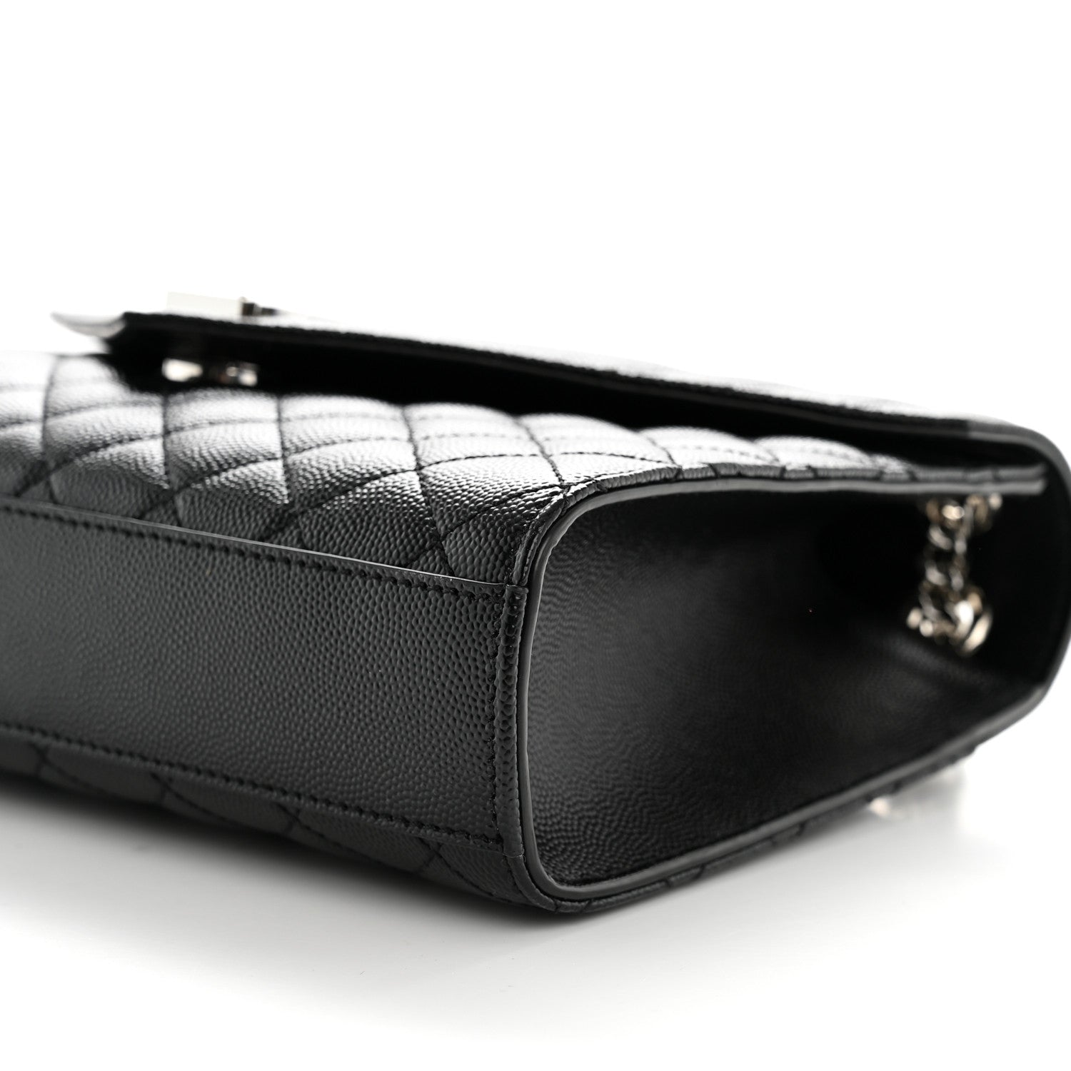 Black matelasse leather satchel with quilted paneling and top zipper opening