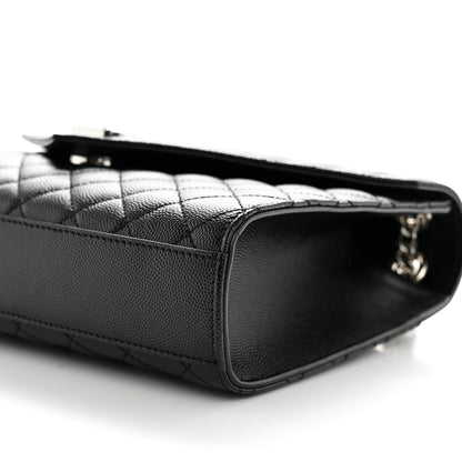 Black matelasse leather satchel with quilted paneling and top zipper opening
