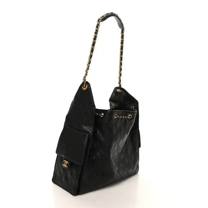 Black Chanel leather tote with gold chain strap, quilted panels, and CC logo