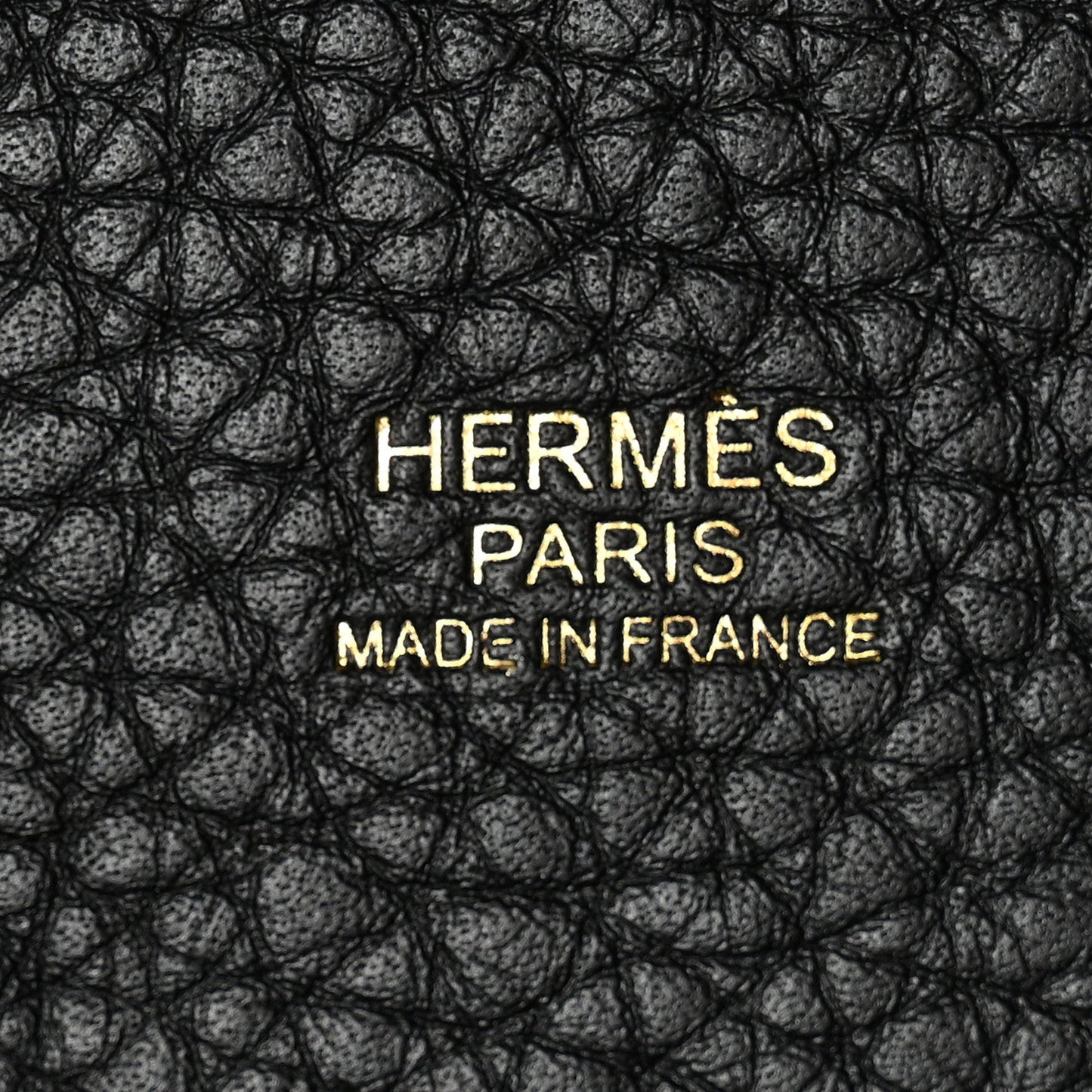 Black pebbled leather close-up with HERMES PARIS MADE IN FRANCE text