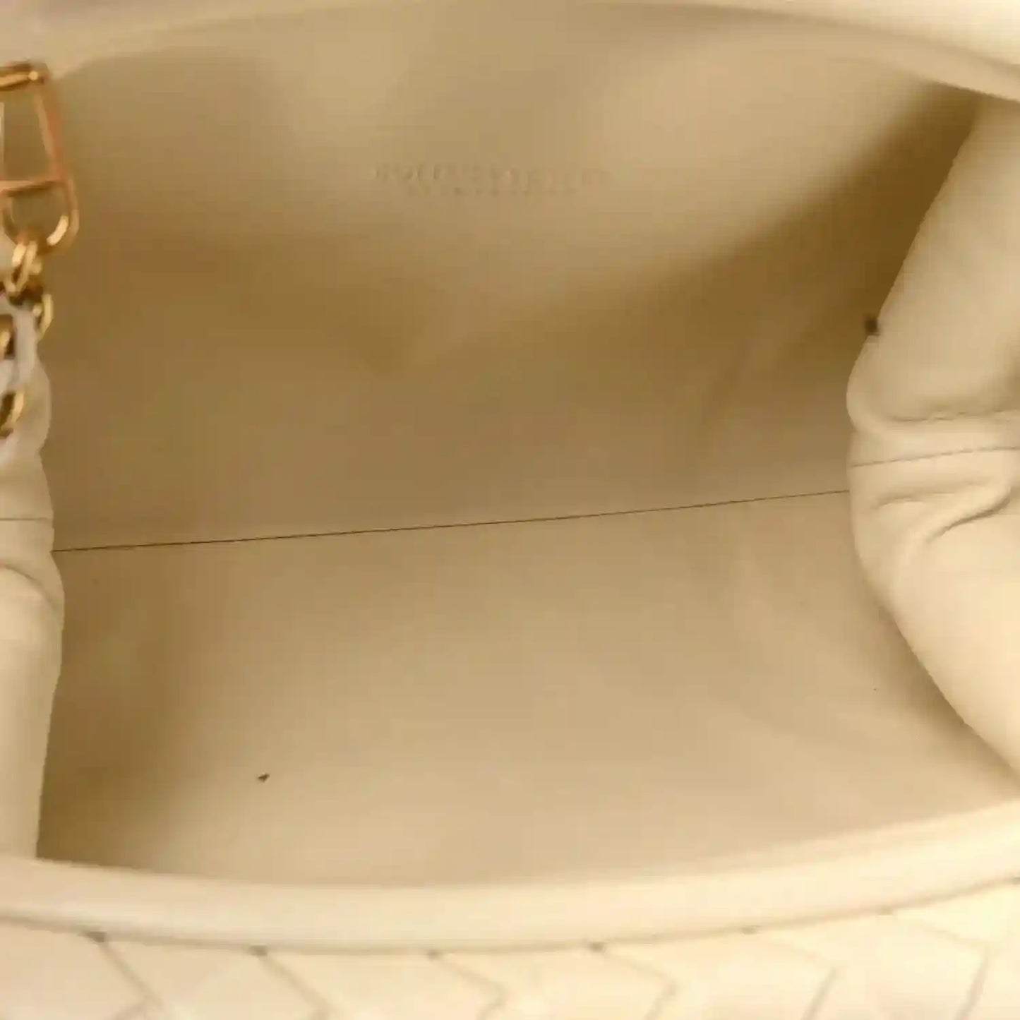 White leather clutch interior showing smooth lining and opening