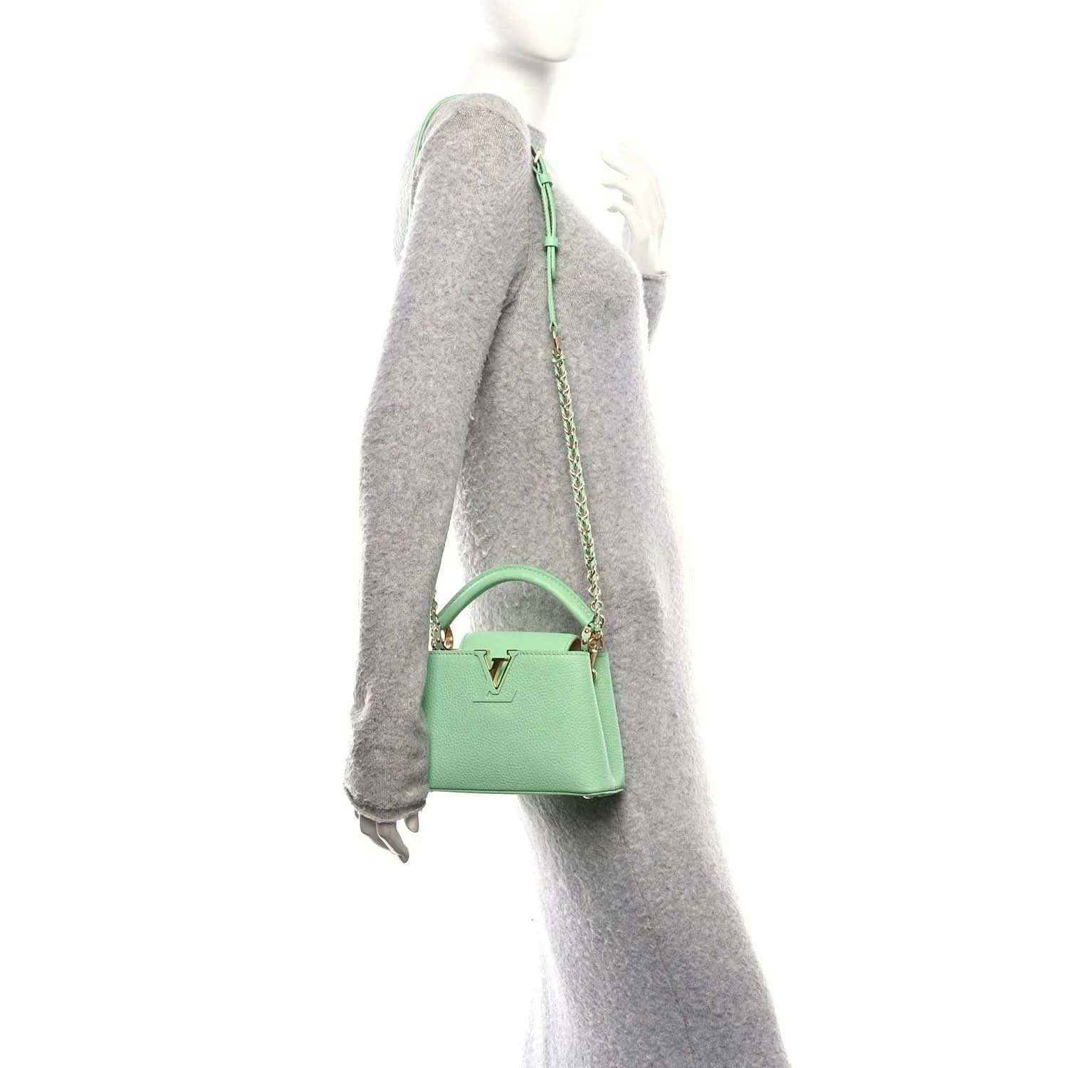 Green mini handbag with chain strap, side view