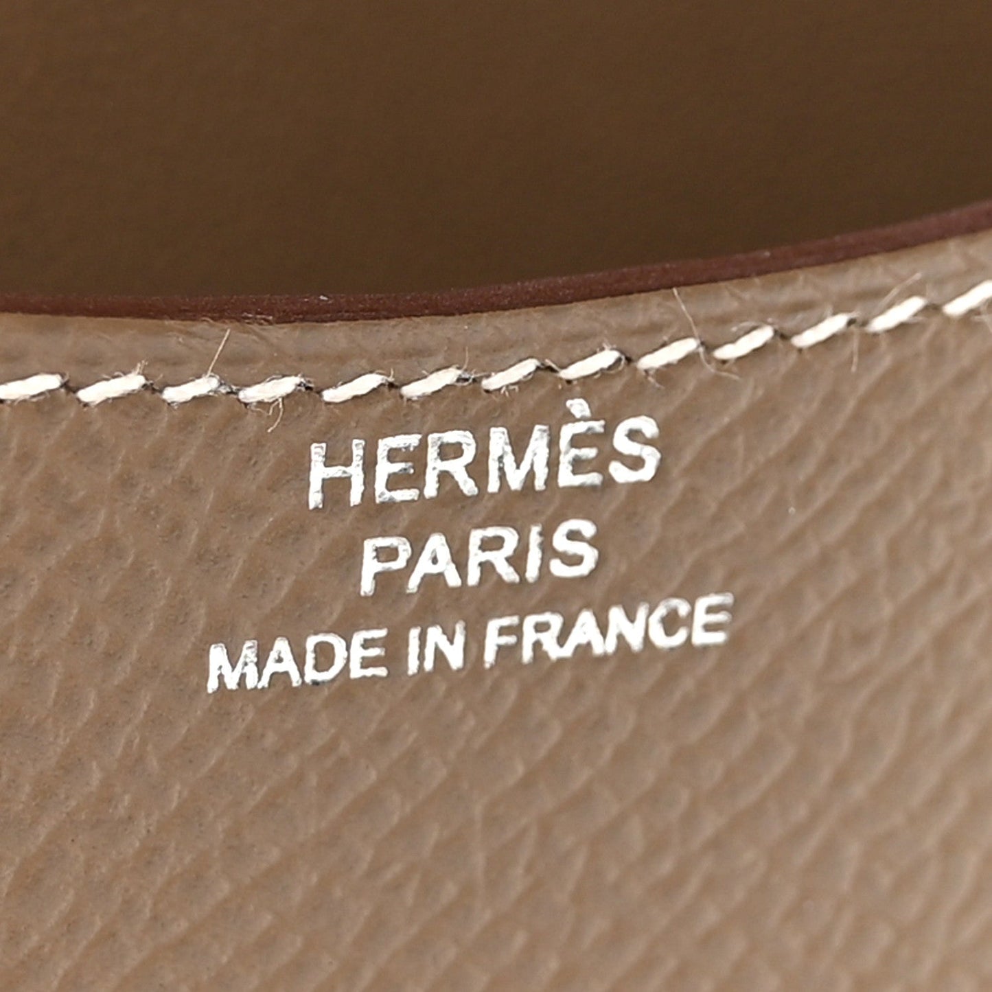 Hermes logo stamping on textured brown leather: HERMES PARIS MADE IN FRANCE