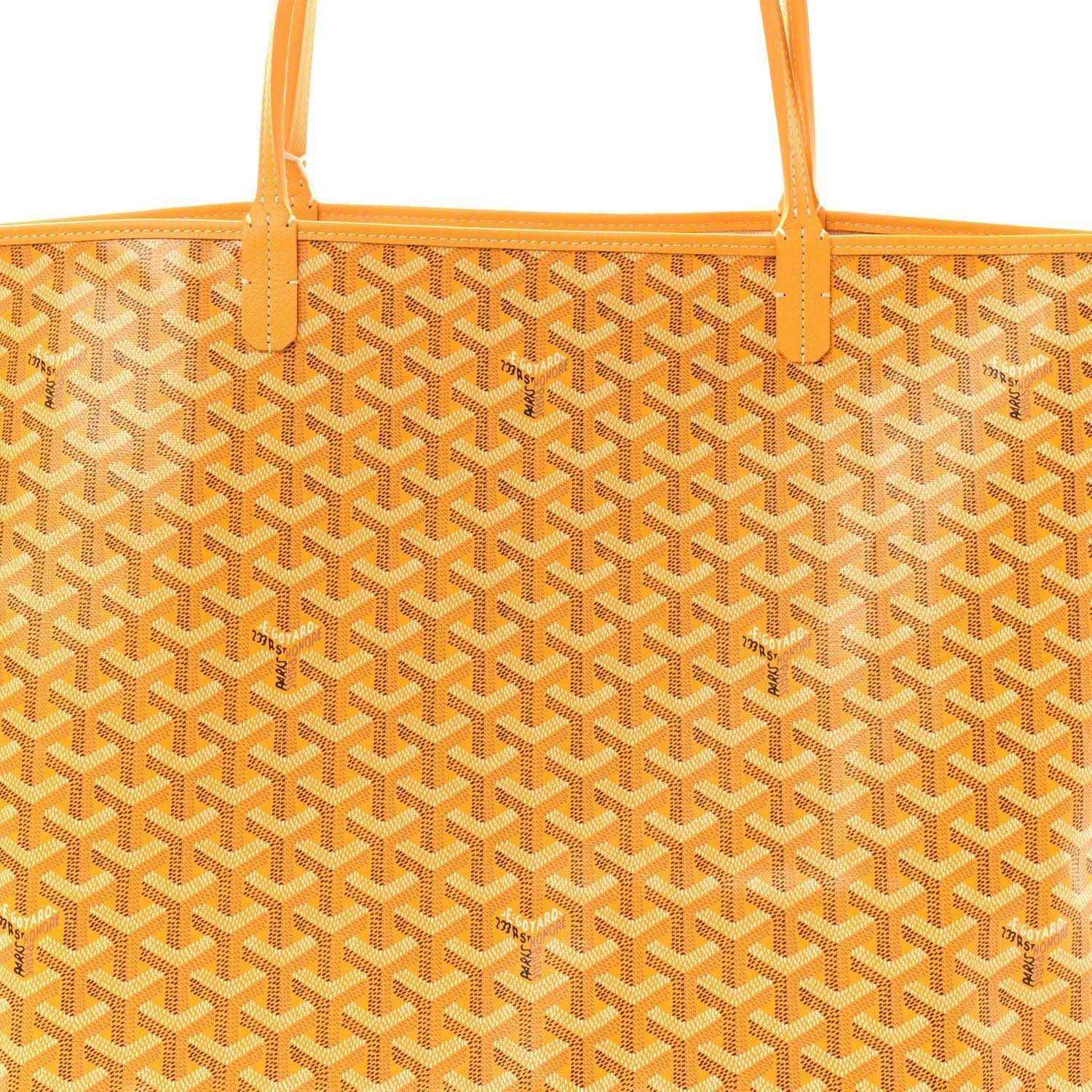 Yellow canvas tote bag with repeating Goyardine pattern and orange top edge