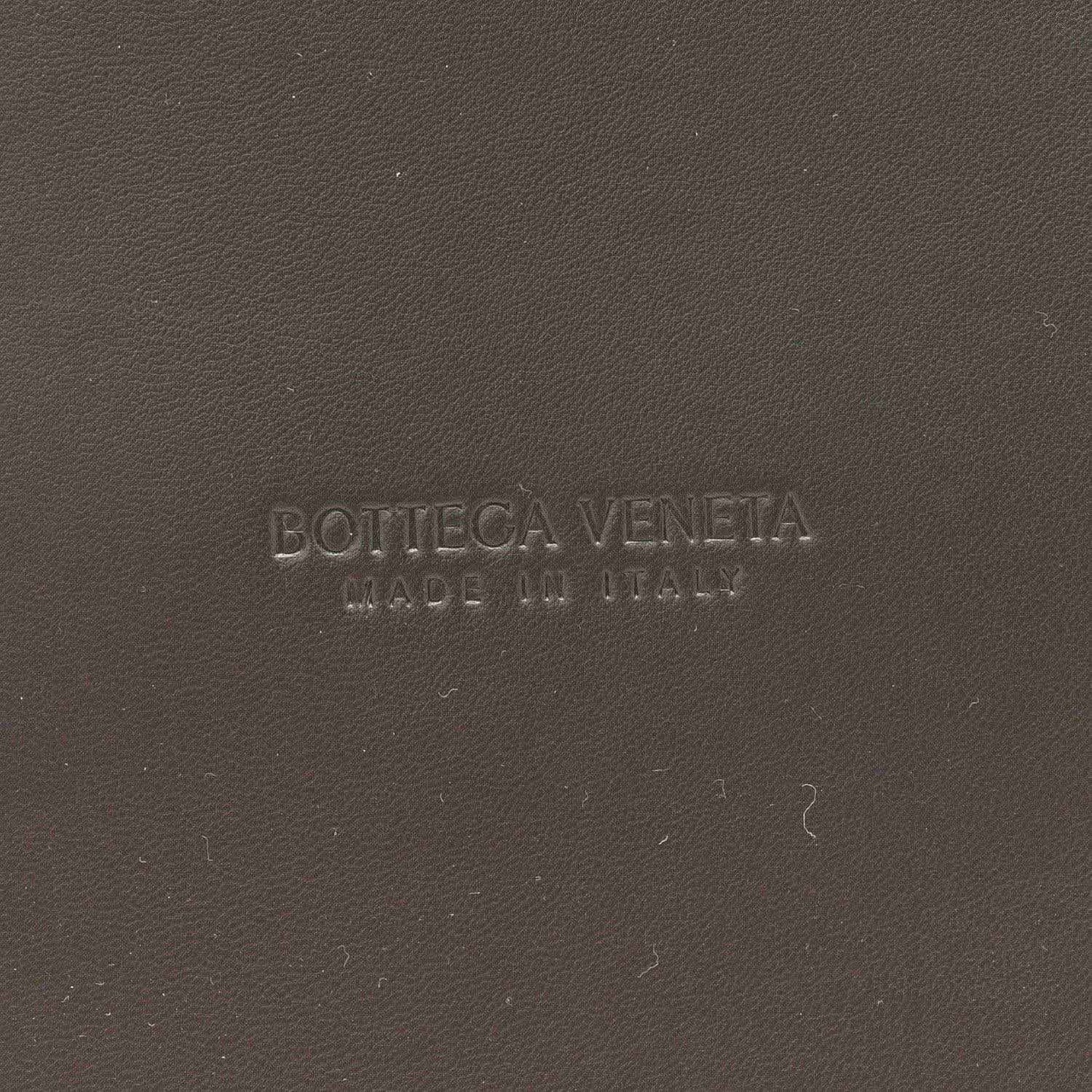 Bottega Veneta embossed on black leather surface