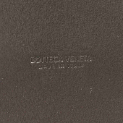 Bottega Veneta embossed on black leather surface