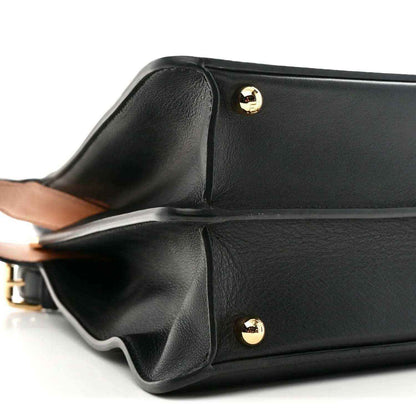 Medium black shiny leather satchel with gold-tone hardware and curved flap detail