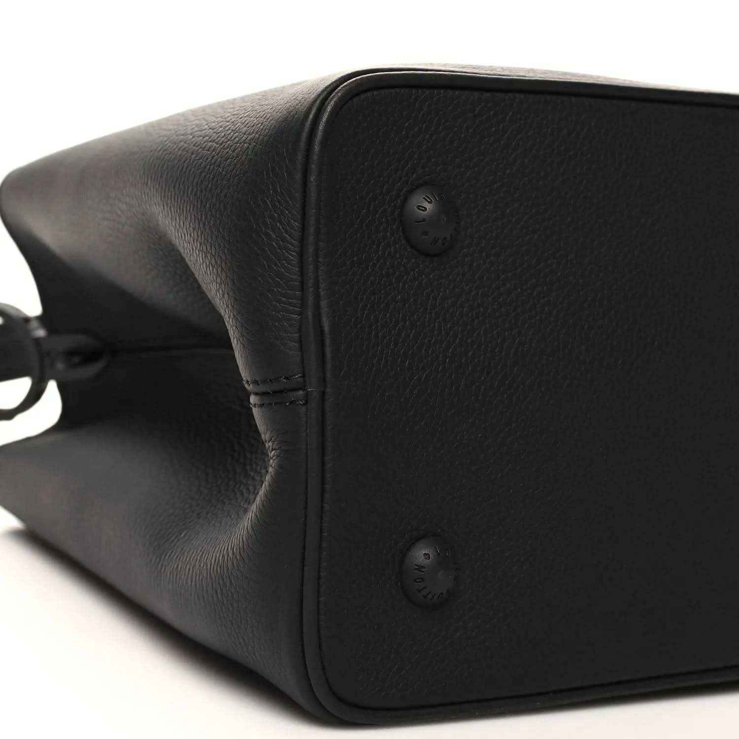 Black matte leather handbag side with corner studs and smooth curved edge