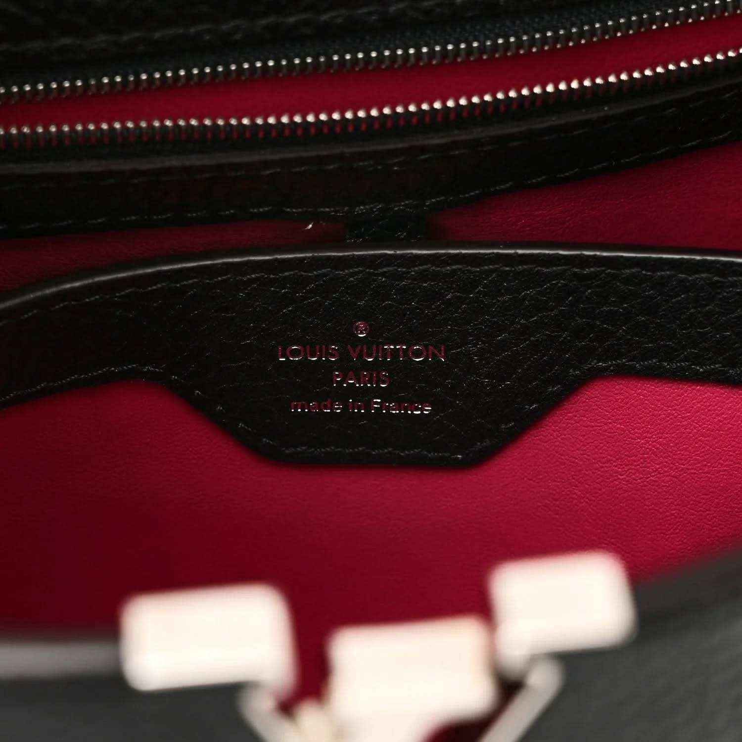 Black leather interior panel with fuchsia lining and embossed logo stamp