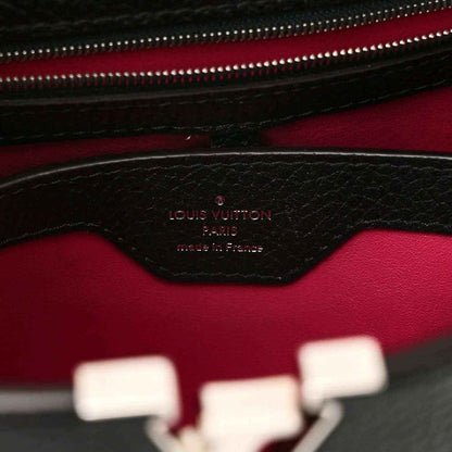 Black leather interior panel with fuchsia lining and embossed logo stamp