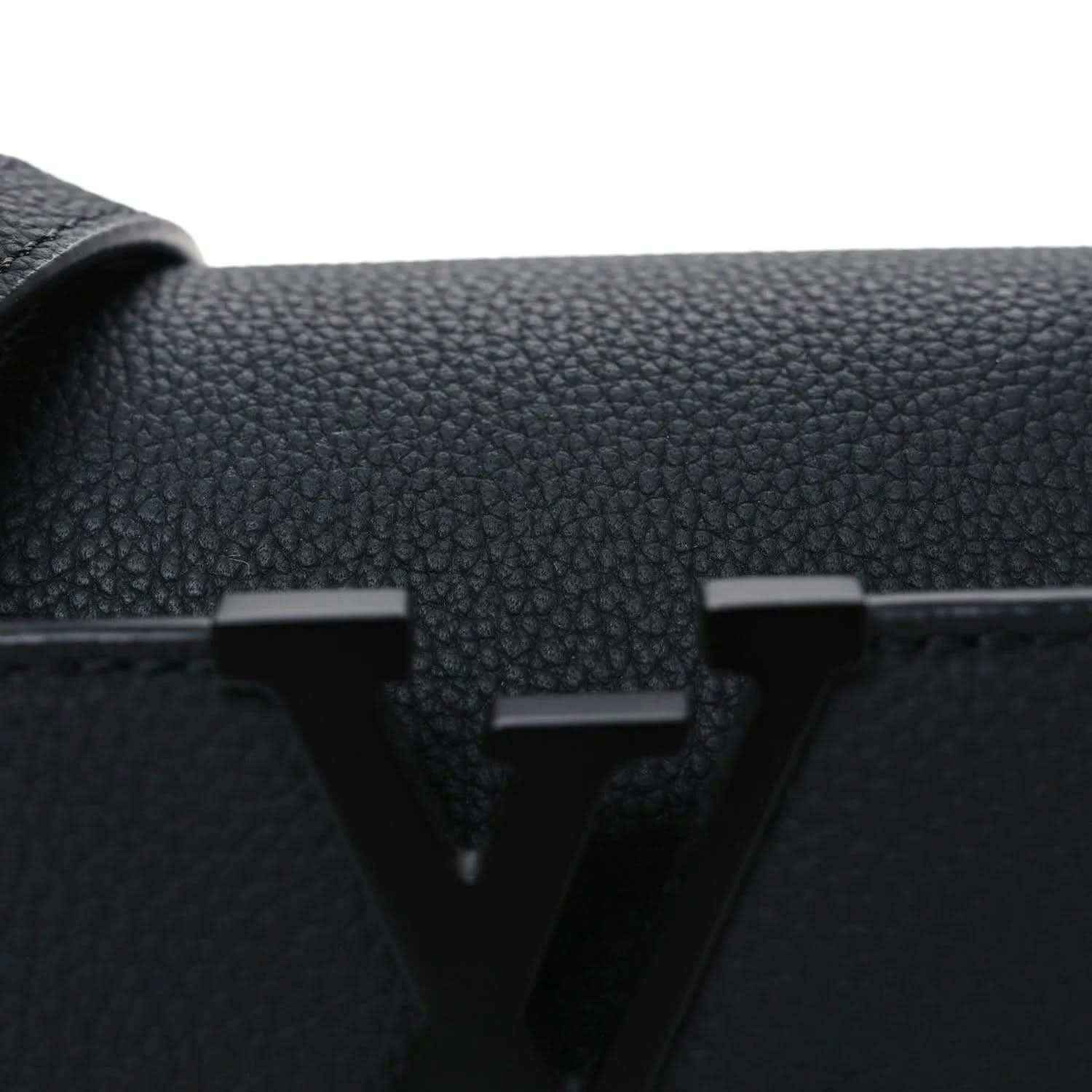 Black leather mini handbag front with raised LV emblem and textured grain.