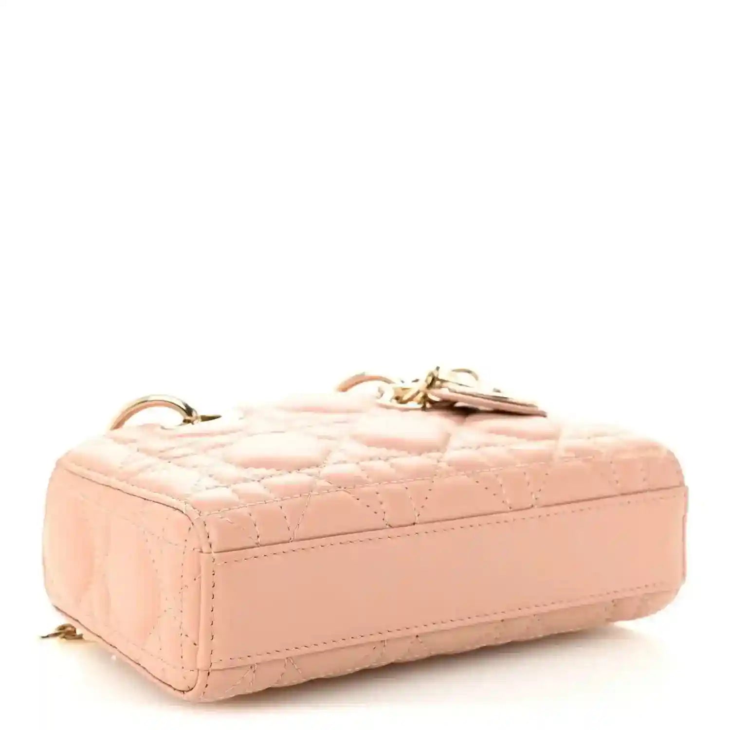 Pink beige quilted micro handbag with structured top and gold-tone hardware on corners