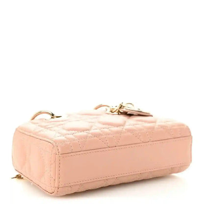 Pink beige quilted micro handbag with structured top and gold-tone hardware on corners