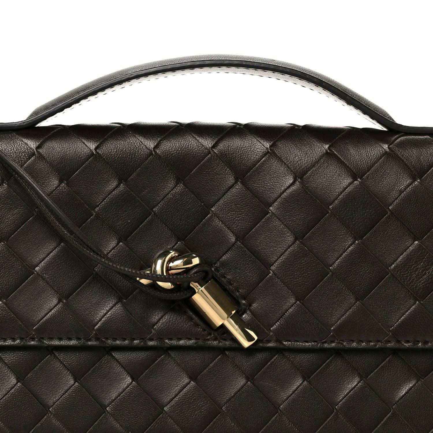 Bottega Veneta Intrecciato clutch with gold lock clasp and woven leather texture