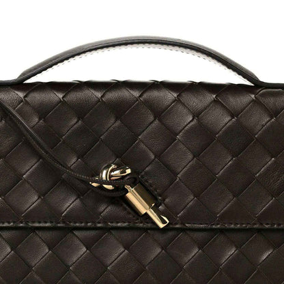 Bottega Veneta Intrecciato clutch with gold lock clasp and woven leather texture