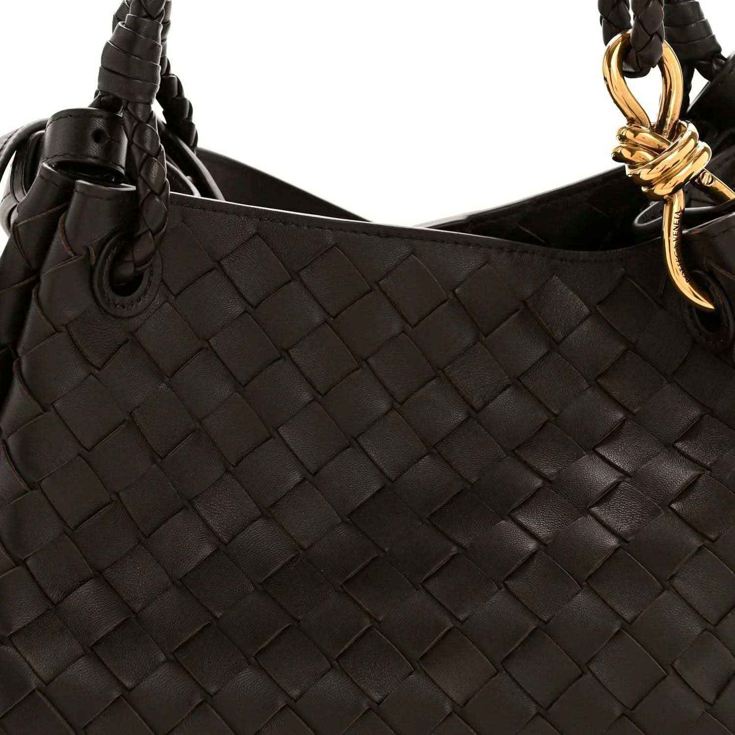 Black leather shoulder bag with intrecciato weave and gold ring clasp