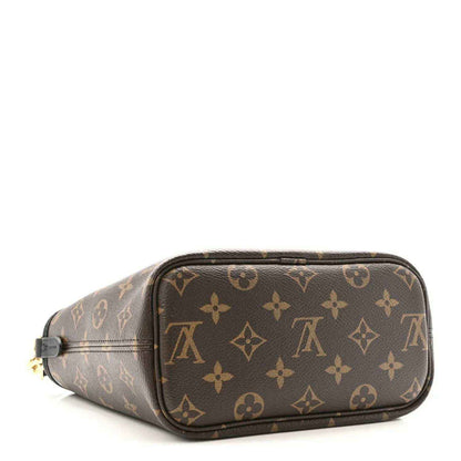 Monogram mini pouch with top zipper and black trim; brown patterned canvas body
