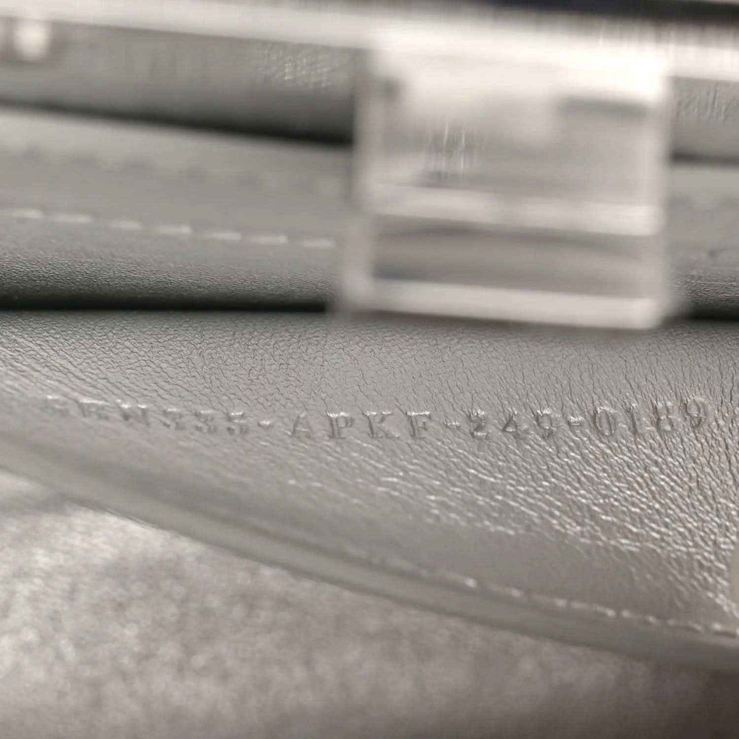 Silver leather interior with embossed maker text near clasp