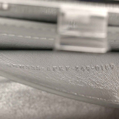 Silver leather interior with embossed maker text near clasp