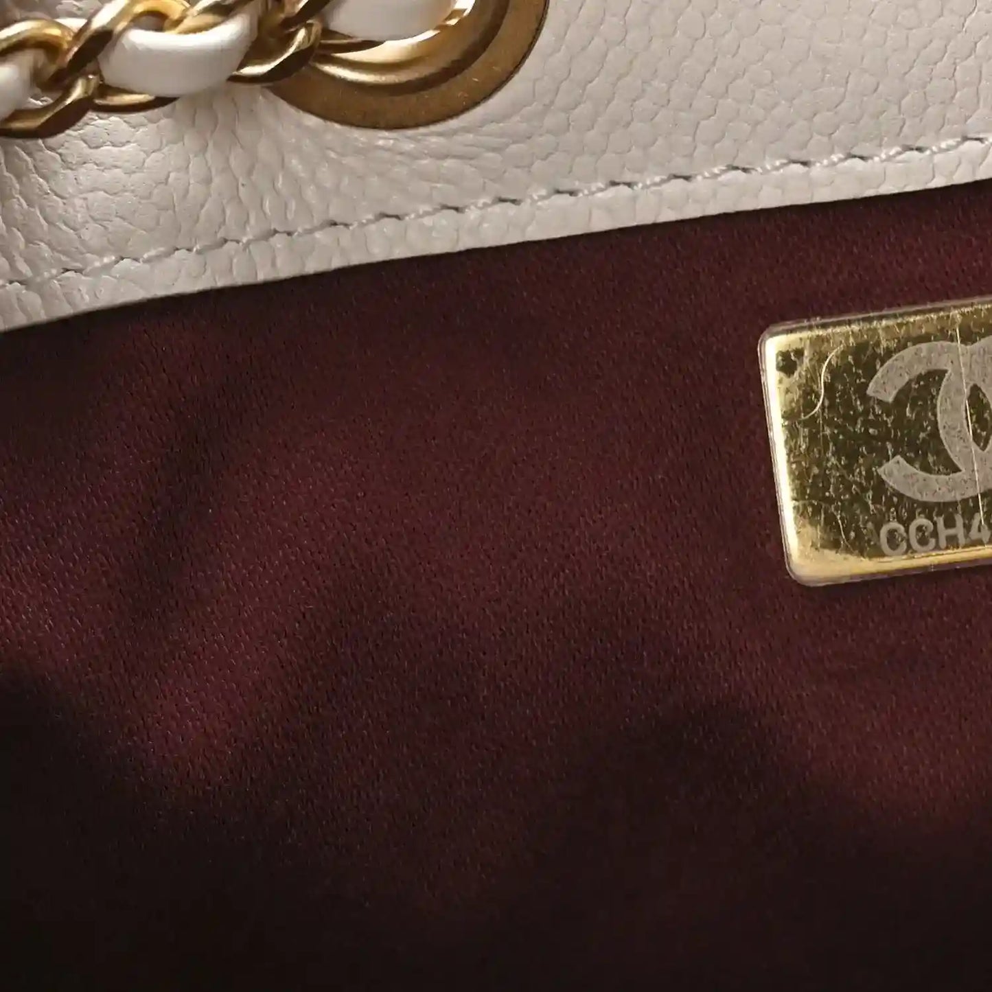 White quilted mini handbag with gold logo plate and chain strap