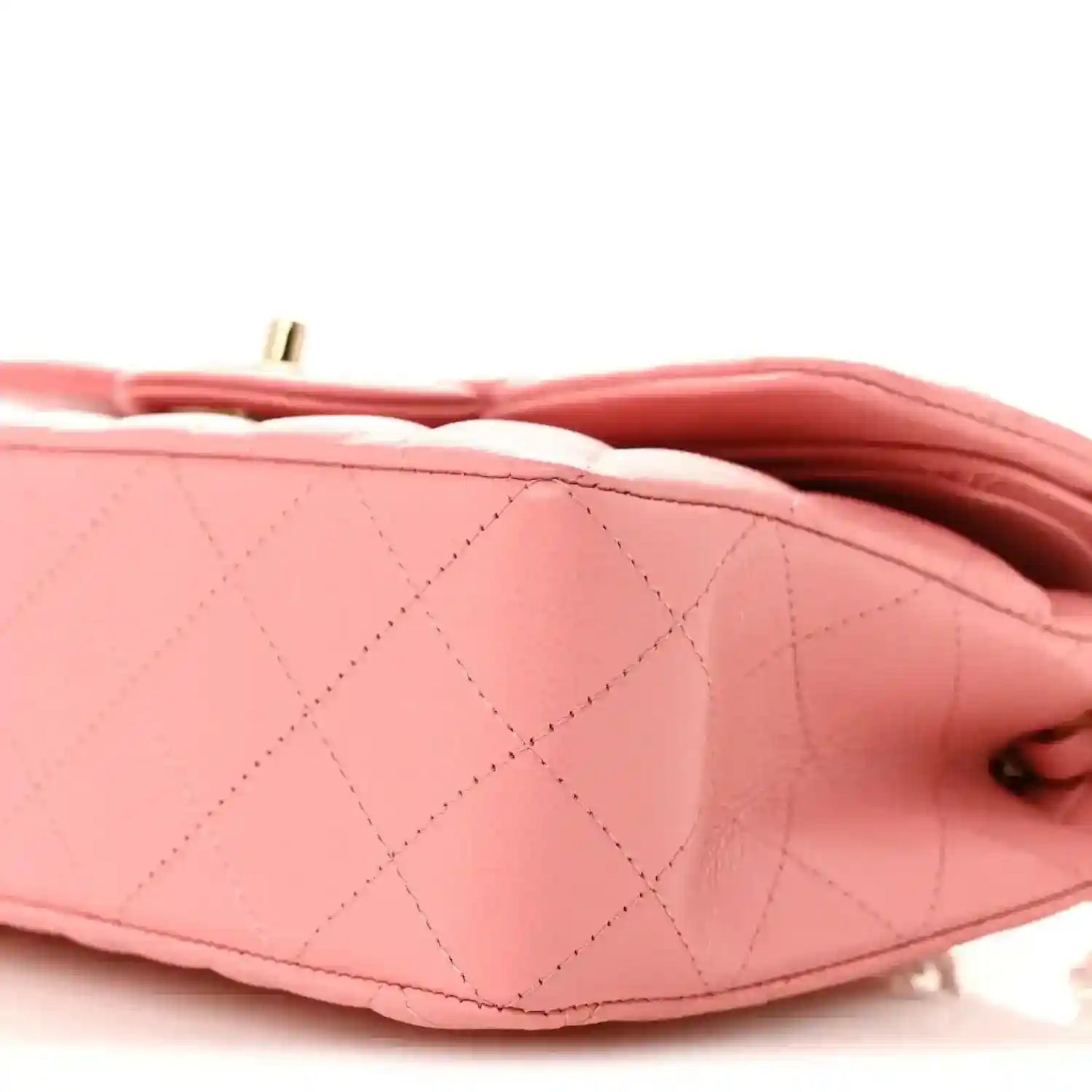 Light pink quilted bag flap seam with inner lining and gold-tone hardware loop