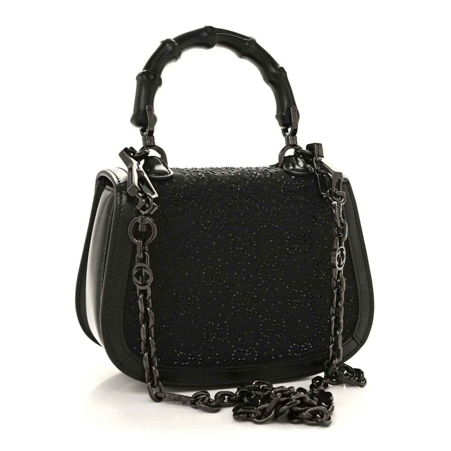 Black mini handbag with chain strap and top handle, textured surface and front clasp.