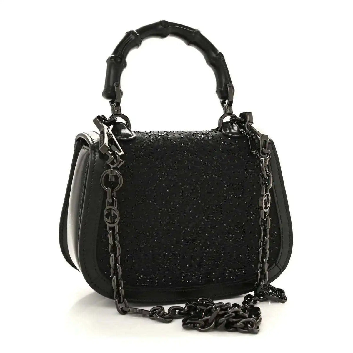 Black mini handbag with chain strap and top handle, textured surface and front clasp.