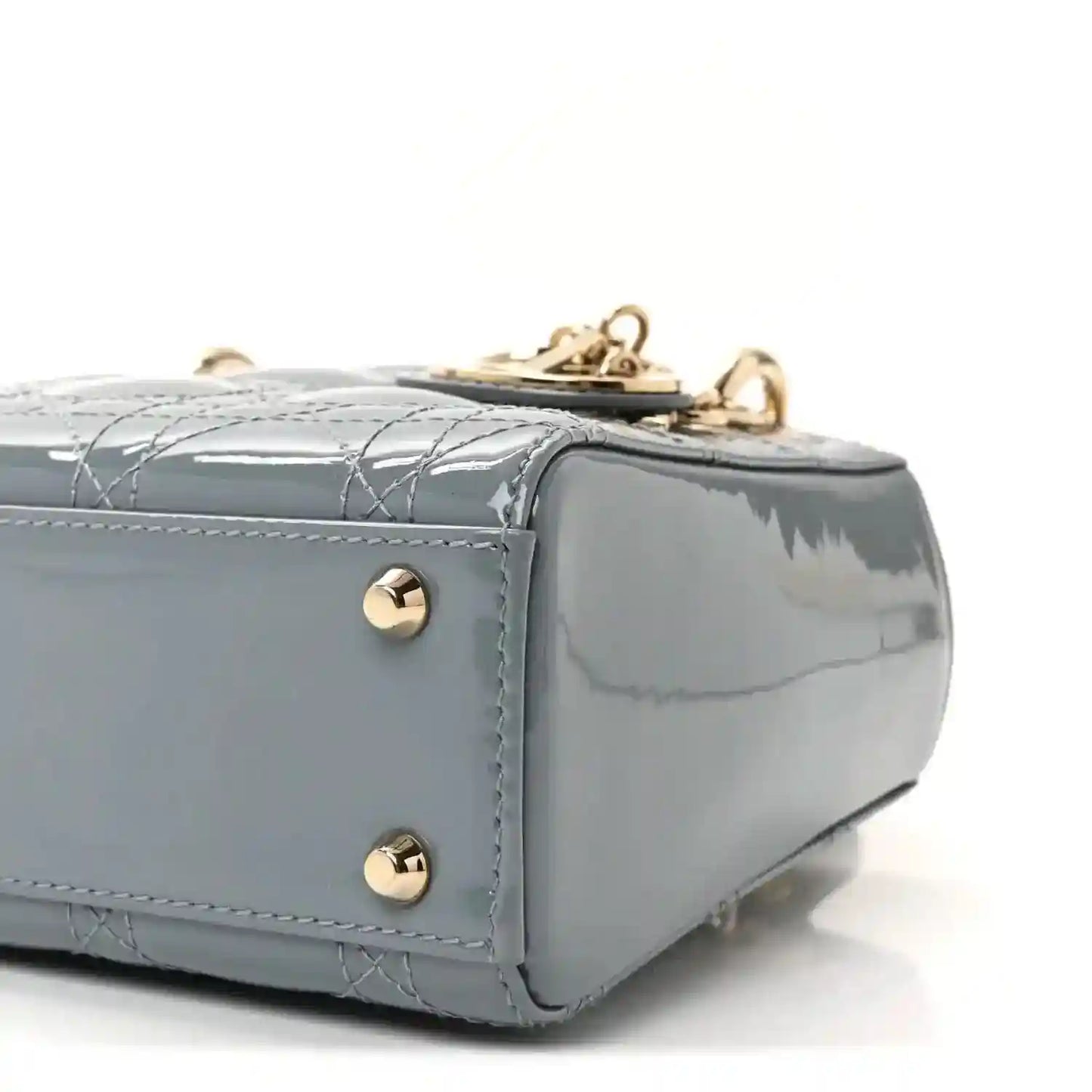 Light blue patent mini Lady Dior bag corner view with gold-tone studs and top hardware