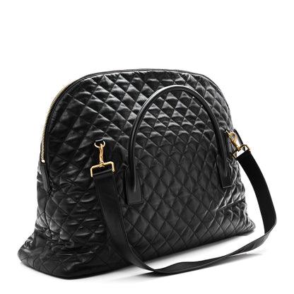 Saint Laurent ES quilted travel bag in black leather, front zipper and gold logo plaque.