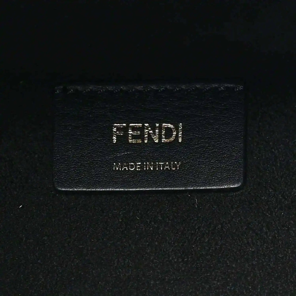 Black leather tote bag brand patch with FENDI and Made in Italy text