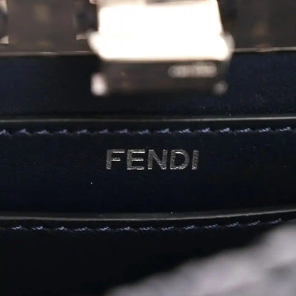 FENDI logo embossing on dark leather lining with stitched trim