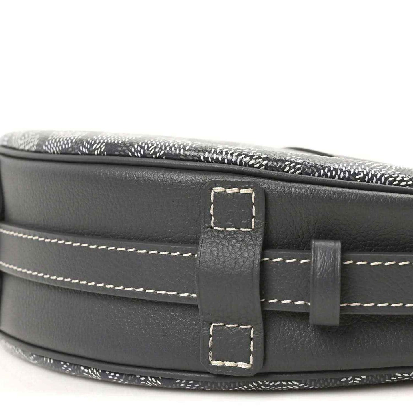 Dark leather strap attachment with rectangular buckle on canvas bag