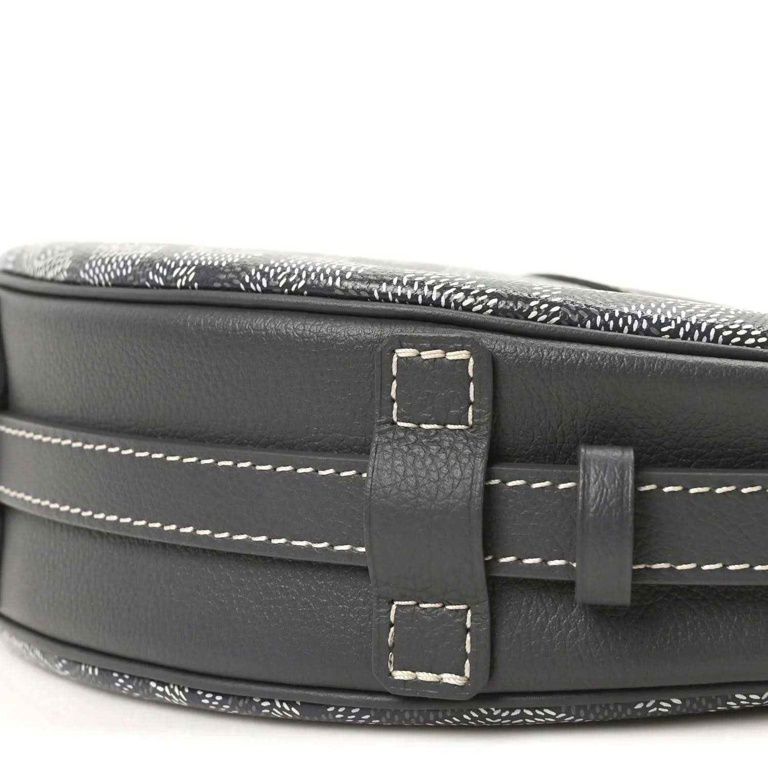 Dark leather strap attachment with rectangular buckle on canvas bag