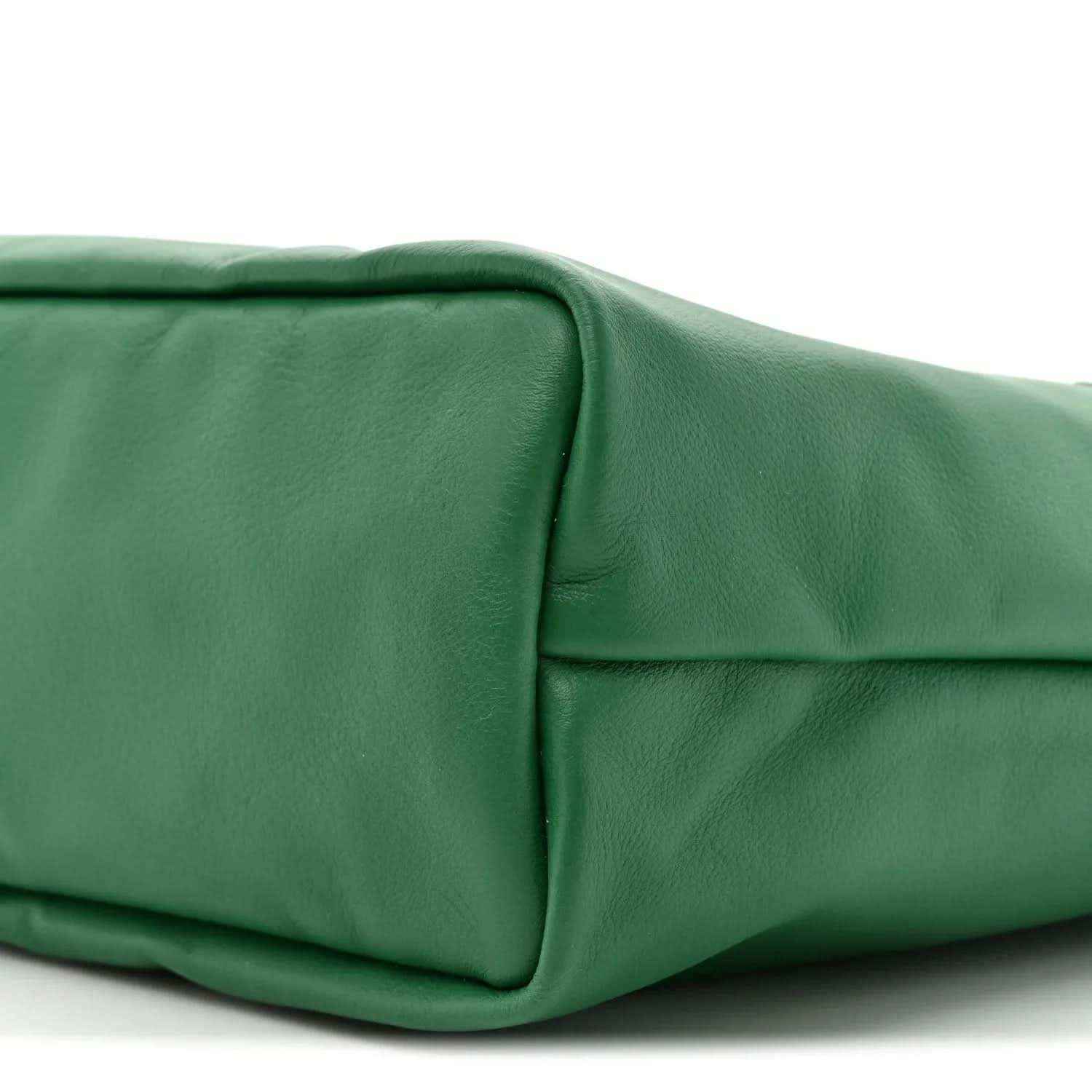 Reversible tote bag corner and base in green coated canvas with seam detail