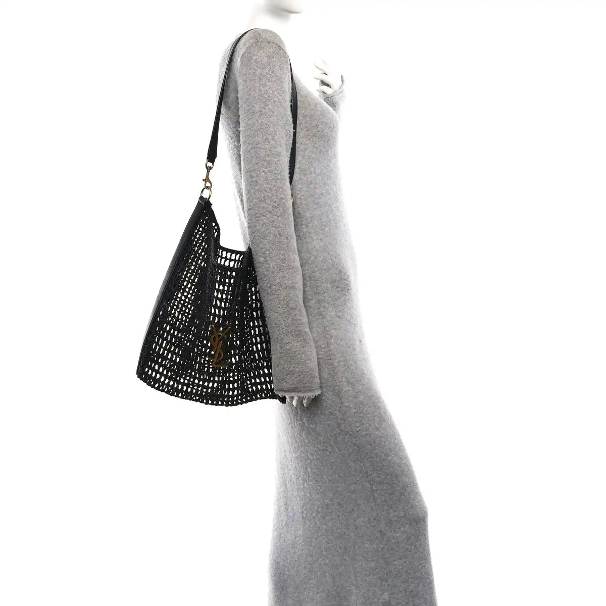 Black shoulder bag with netted raffia texture and leather shoulder strap, side view