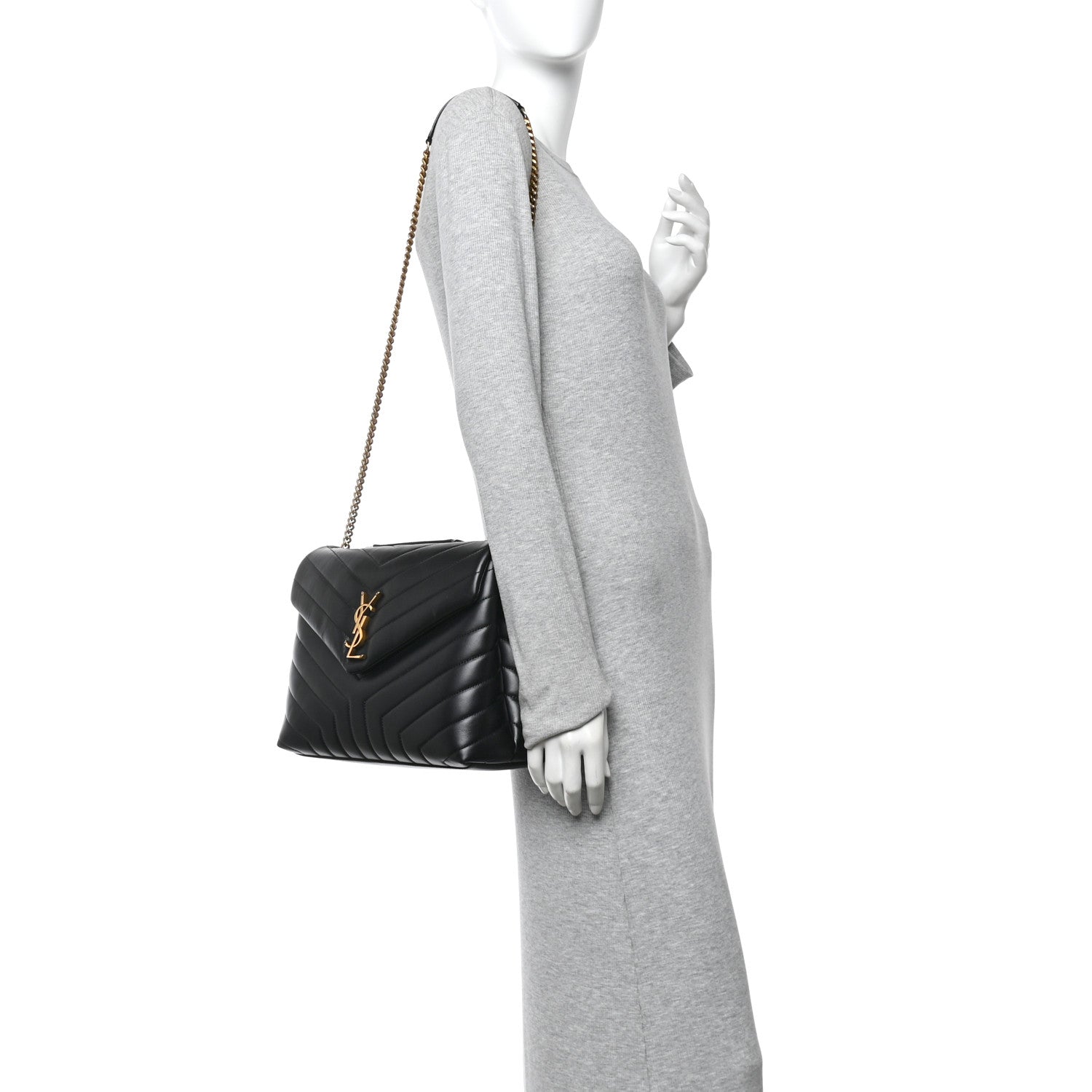 Black quilted calfskin satchel with gold chain strap, worn crossbody