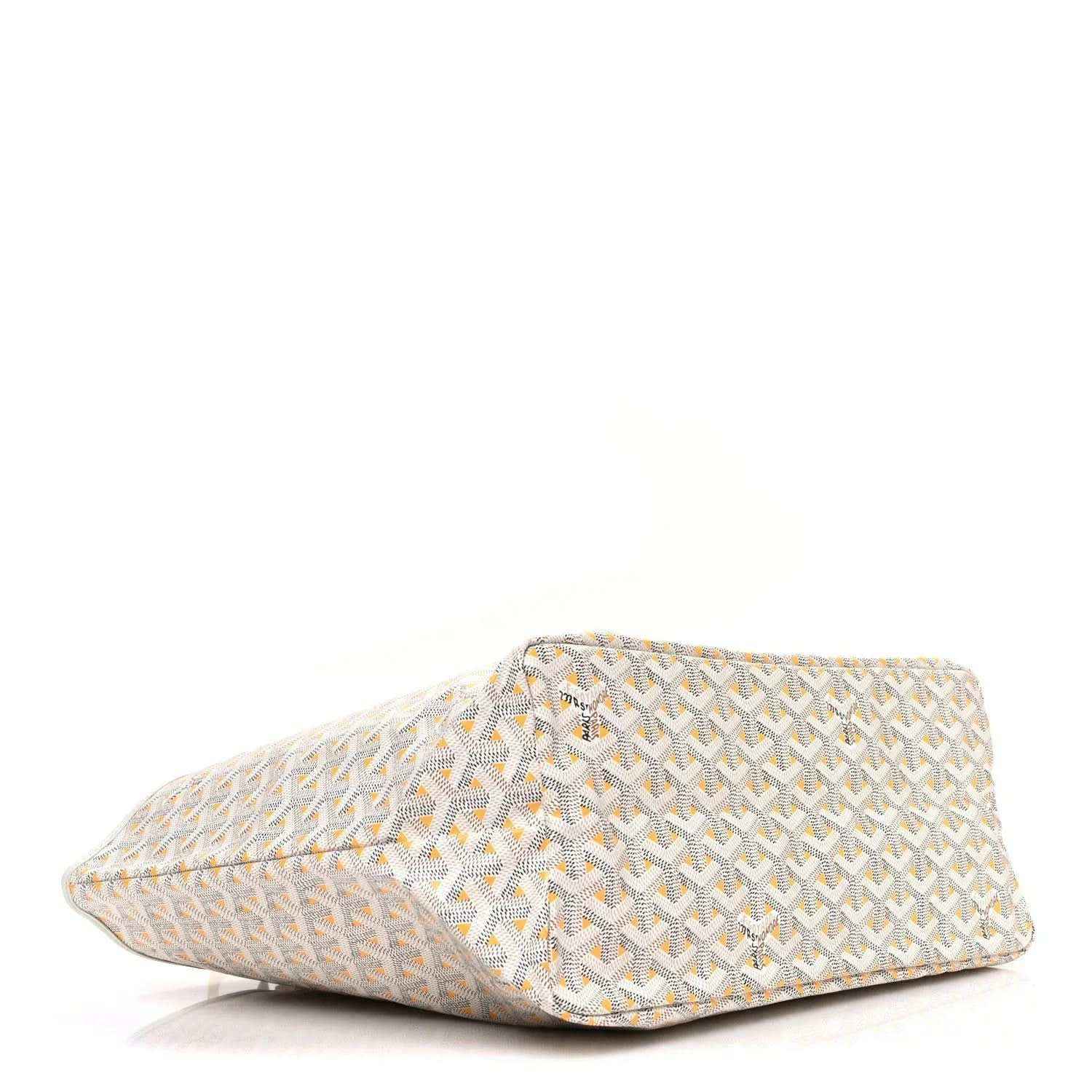 White and yellow patterned pouch with triangular shape and stitched edges