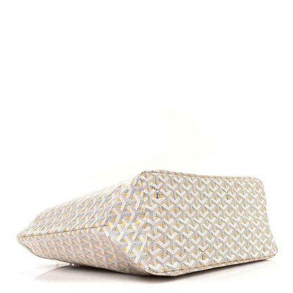 White and yellow patterned pouch with triangular shape and stitched edges