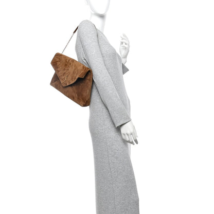 Caramel suede pouch on-chain bag worn over the shoulder with gold chain