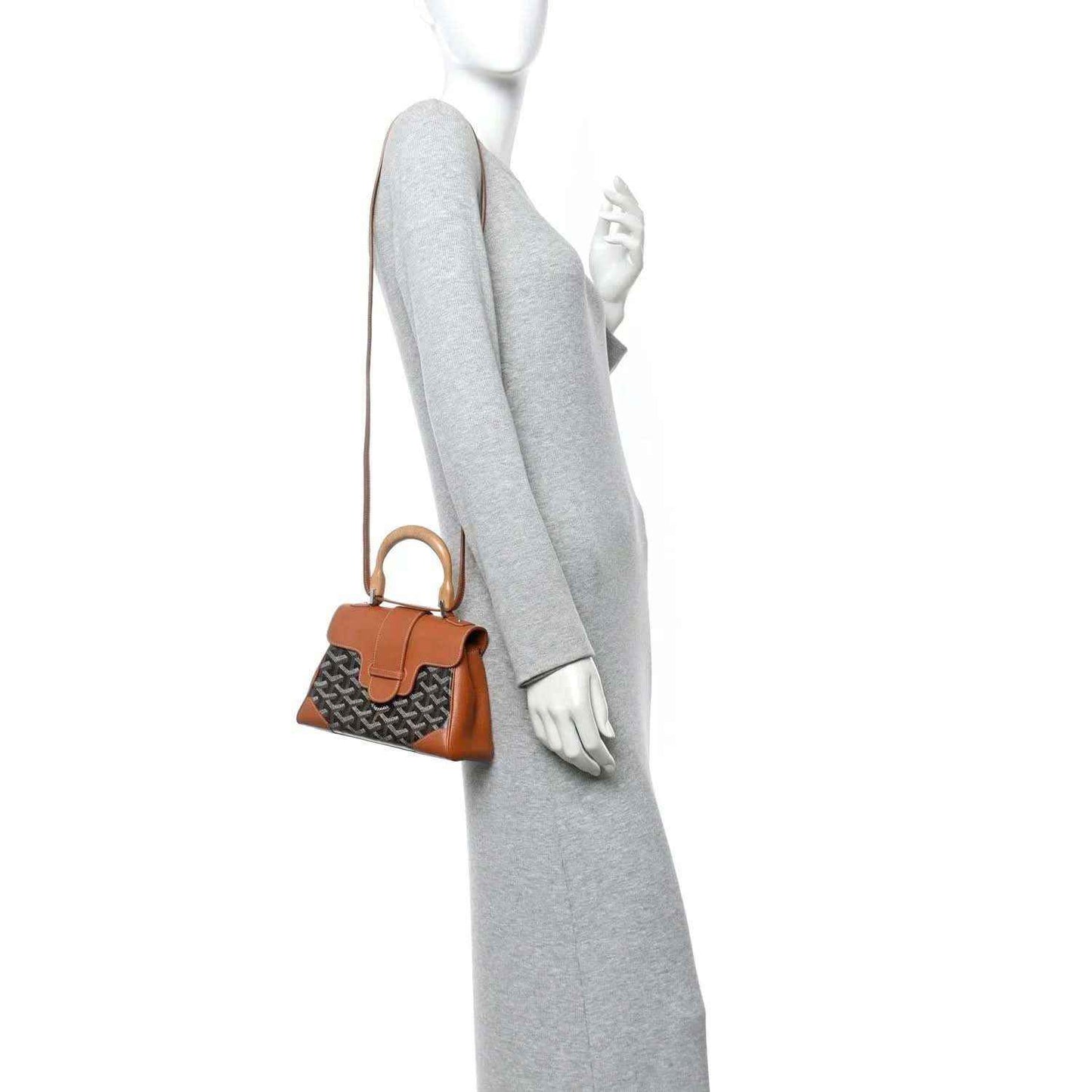 Mini Saigon bag worn on model, small crossbody strap, patterned body with brown leather trim