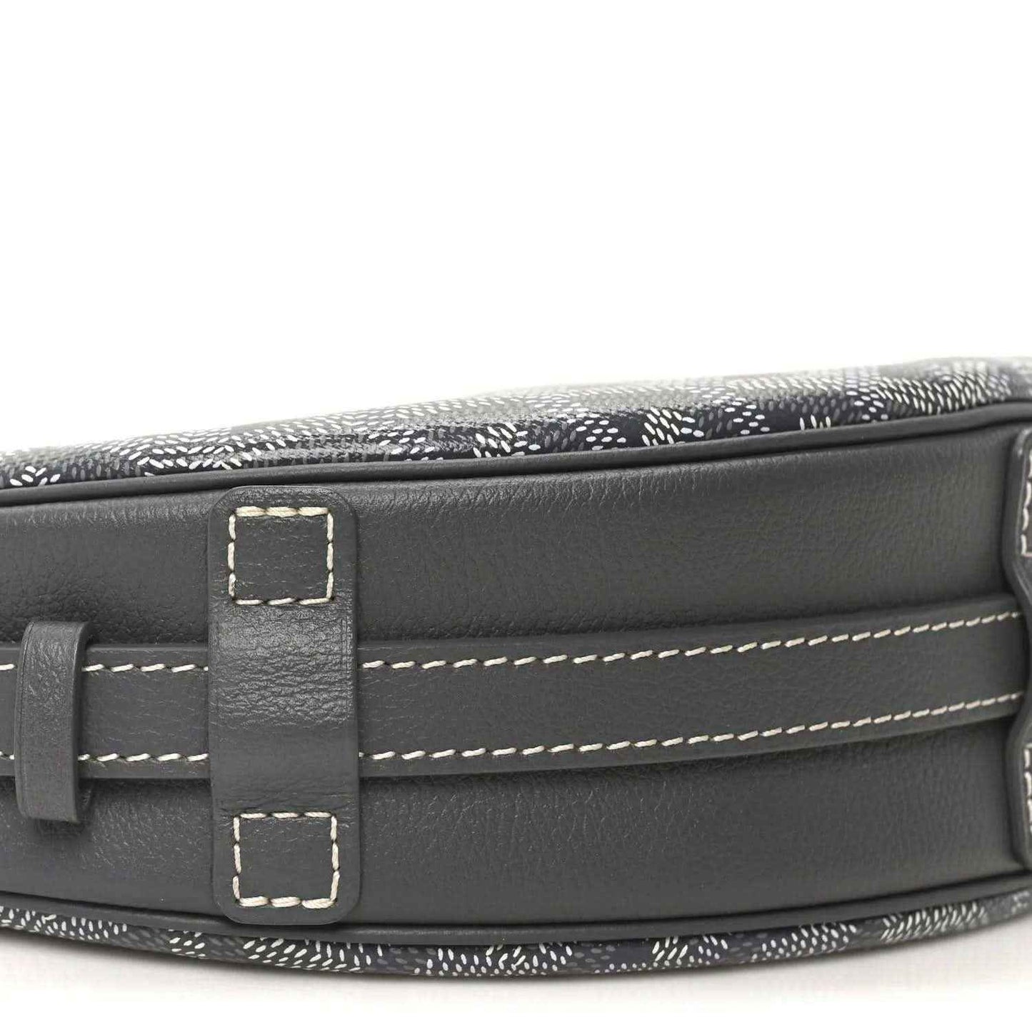 Canvas top edge with dark leather flap, stitching, and strap attachment