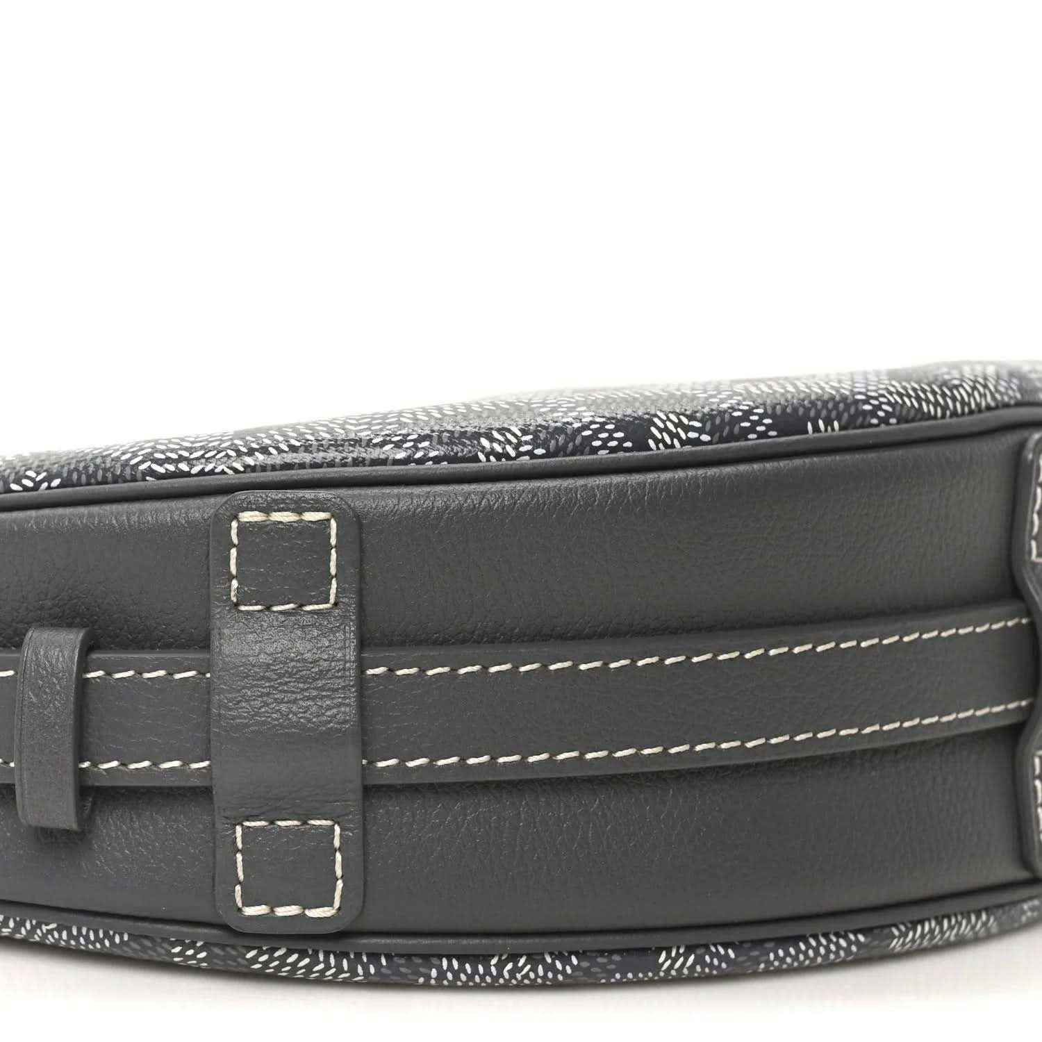 Canvas top edge with dark leather flap, stitching, and strap attachment