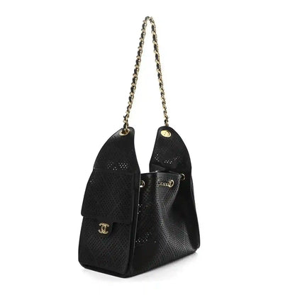 Chanel small handbag in black perforated calfskin with gold chain and front logo