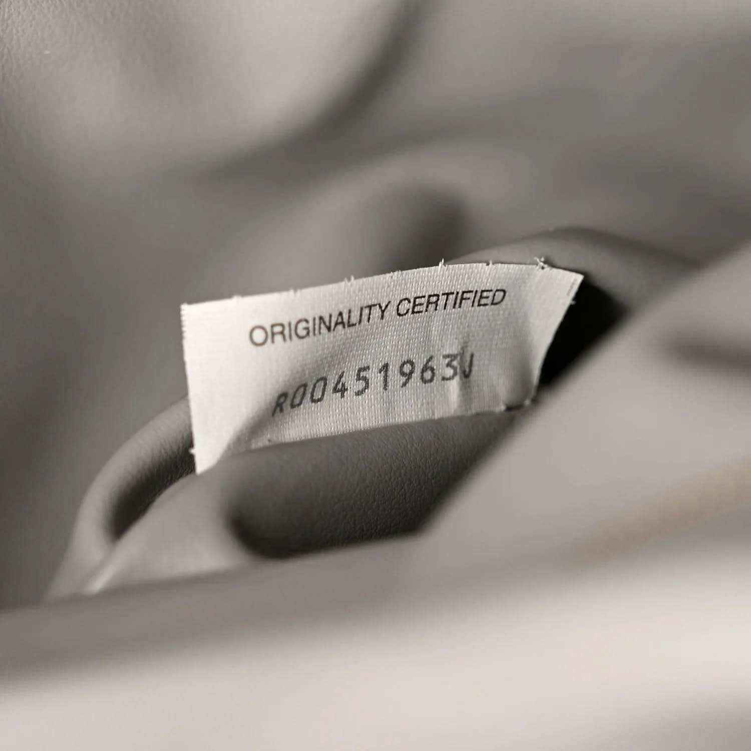 Suede authenticity tag reading Originality Certified with code